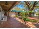 Charming backyard patio featuring tile flooring, a beautiful garden and comfortable rocking chairs at 4942 Cr 300, Lake Panasoffkee, FL 33538