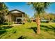 Open RV storage on a well-maintained lawn with ample parking and a backdrop of lush greenery at 4942 Cr 300, Lake Panasoffkee, FL 33538
