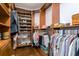 Organized walk-in closet featuring custom shelving, wooden drawers, and ample storage for shoes and hanging clothes at 4942 Cr 300, Lake Panasoffkee, FL 33538