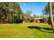 Green yard featuring a shed, covered storage, and barn, perfect for outdoor activities at 4942 Cr 300, Lake Panasoffkee, FL 33538