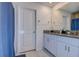 Bright bathroom featuring a granite countertop vanity, white cabinets, and a shower with a blue curtain at 2244 Teneroc Trl, Lakeland, FL 33805