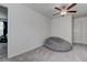 Cozy bedroom featuring plush carpet, ceiling fan, and a comfortable beanbag chair, creating a relaxing retreat at 2244 Teneroc Trl, Lakeland, FL 33805