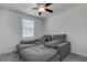 Cozy bedroom featuring a ceiling fan and a comfortable gray sofa, creating a relaxing space at 2244 Teneroc Trl, Lakeland, FL 33805