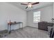 Bedroom with a ceiling fan, window, black desk and dresser offering comfort and functionality at 2244 Teneroc Trl, Lakeland, FL 33805