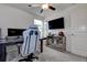 Bedroom featuring a ceiling fan and desk setup, creating a functional space for work and relaxation at 2244 Teneroc Trl, Lakeland, FL 33805