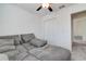 Bedroom featuring a ceiling fan and a gray sofa, plus a closet providing ample storage at 2244 Teneroc Trl, Lakeland, FL 33805