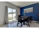 Bright dining area with sliding glass door leading to the backyard, complemented by a bold accent wall and modern artwork at 2244 Teneroc Trl, Lakeland, FL 33805