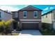 Two-story home showcasing its neutral-toned exterior and attached two-car garage at 2244 Teneroc Trl, Lakeland, FL 33805