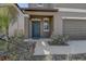 Inviting front porch featuring a stylish blue door and manicured landscaping at 2244 Teneroc Trl, Lakeland, FL 33805