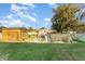 Wide shot of the backyard with mature trees and a shed at the back of the property at 520 S Orange Ave, Fort Meade, FL 33841