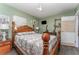 The bedroom includes a decorative wood bed frame, wood floors, and light green walls at 520 S Orange Ave, Fort Meade, FL 33841