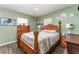 Bedroom features light green walls, wood floors, and wood furniture at 520 S Orange Ave, Fort Meade, FL 33841