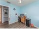 Light blue bedroom features a desk, wood floors, closet and ceiling fan at 520 S Orange Ave, Fort Meade, FL 33841