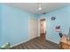 Bedroom with light blue walls, wood floors, a ceiling fan and closet at 520 S Orange Ave, Fort Meade, FL 33841