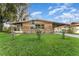 Attractive single-story home with a lush lawn, mature trees, and a covered carport at 520 S Orange Ave, Fort Meade, FL 33841