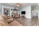 Cozy living room with wood flooring, comfortable seating, and a ceiling fan at 520 S Orange Ave, Fort Meade, FL 33841