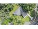 Aerial view of a landscaped backyard with mature trees surrounding a charming home at 407 W Oak Dr, Lakeland, FL 33803