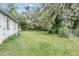 Spacious backyard with mature trees and lush greenery, perfect for outdoor activities at 407 W Oak Dr, Lakeland, FL 33803