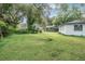 Expansive backyard offers ample space with mature trees, providing shade and privacy at 407 W Oak Dr, Lakeland, FL 33803
