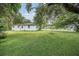 Lush backyard provides ample space for activities with a nice lawn and mature trees at 407 W Oak Dr, Lakeland, FL 33803