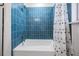 Clean bathroom with tiled walls, bathtub, and shower at 407 W Oak Dr, Lakeland, FL 33803