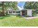 Stylish single-story house featuring a unique design, bright front door, and a spacious yard at 407 W Oak Dr, Lakeland, FL 33803