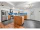 Charming kitchen featuring stainless steel appliances, an island and stylish blue backsplash at 407 W Oak Dr, Lakeland, FL 33803