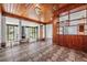 Spacious living area featuring a unique tiled floor, wood accents, and a view of the front yard at 407 W Oak Dr, Lakeland, FL 33803