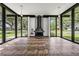 Bright sunroom with large windows, unique stone tile flooring, and a modern fireplace at 407 W Oak Dr, Lakeland, FL 33803