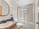 Bathroom featuring shower-tub combo with glass doors, single sink vanity, and tile floor at 4845 Sw 78Th Ave, Bushnell, FL 33513