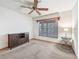 Cozy bedroom with ceiling fan, neutral carpet, and a window with wood trim and blinds at 4845 Sw 78Th Ave, Bushnell, FL 33513