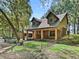 Beautiful home with a stone porch and dark trim surrounded by a fenced in yard and mature trees at 4845 Sw 78Th Ave, Bushnell, FL 33513