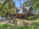 Charming home featuring a covered porch with stone accents and a beautifully landscaped front yard at 4845 Sw 78Th Ave, Bushnell, FL 33513