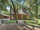 Inviting single-Gathering home with stone pillar accents, fenced front yard, and mature trees at 4845 Sw 78Th Ave, Bushnell, FL 33513