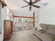 Bright loft area with a cozy couch, wooden railing, and natural light at 4845 Sw 78Th Ave, Bushnell, FL 33513