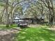 Picturesque outbuildings surrounded by mature trees, lush grass, and a convenient trailer for hauling at 4845 Sw 78Th Ave, Bushnell, FL 33513