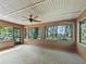 Enclosed patio with large windows, a ceiling fan, and views of the lush backyard at 4845 Sw 78Th Ave, Bushnell, FL 33513