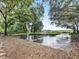 Outdoor property featuring rows of container trees, irrigation, and views of the fields beyond the fence at 4845 Sw 78Th Ave, Bushnell, FL 33513