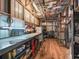 Interior view of the workshop showcasing a functional workspace, storage, and a vintage ceiling fan at 4845 Sw 78Th Ave, Bushnell, FL 33513