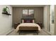 Inviting bedroom featuring a plush bed, side tables, and stylish wall decor at 772 Osprey Roost Dr, Lakeland, FL 33801