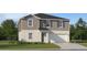 Charming two-story home with gray siding, a two-car garage, and a well-maintained lawn at 772 Osprey Roost Dr, Lakeland, FL 33801