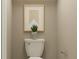 Cozy powder room featuring a white toilet with succulent sitting on top for decor at 950 Hour Glass Rd, Lakeland, FL 33801