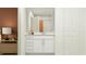 Well-lit bathroom with white cabinetry, a spacious countertop, and view of the shower at 955 Hour Glass Rd, Lakeland, FL 33801