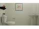 Simple powder room with a toilet, pedestal sink, and stylish decorations at 955 Hour Glass Rd, Lakeland, FL 33801