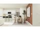 A modern dining area that transitions to a kitchen with stainless steel appliances at 955 Hour Glass Rd, Lakeland, FL 33801