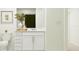 Bright bathroom featuring white vanity, toilet, and modern fixtures with a vase of flowers at 966 Hour Glass Rd, Lakeland, FL 33801