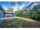 Spacious backyard with a screened lanai and a backdrop of lush greenery at 1126 Waterview E Blvd, Lakeland, FL 33801