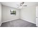 Cozy bedroom with plush carpeting, a ceiling fan, and a bright window at 1126 Waterview E Blvd, Lakeland, FL 33801