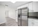 Modern kitchen featuring stainless steel appliances, white cabinetry, and granite countertops at 1126 Waterview E Blvd, Lakeland, FL 33801