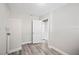 A bright laundry room with new flooring, white walls, and a door that leads to another room at 1126 Waterview E Blvd, Lakeland, FL 33801